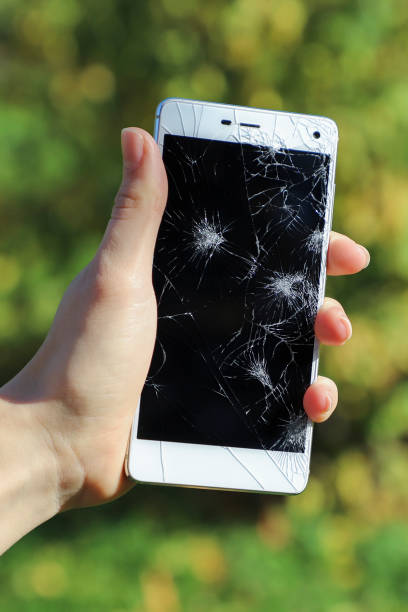 istock Girl holding a broken smart phone. 867363786