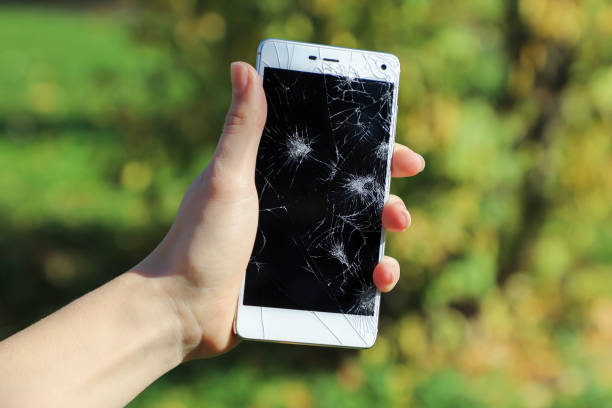istock Girl holding a broken smart phone. 867364784