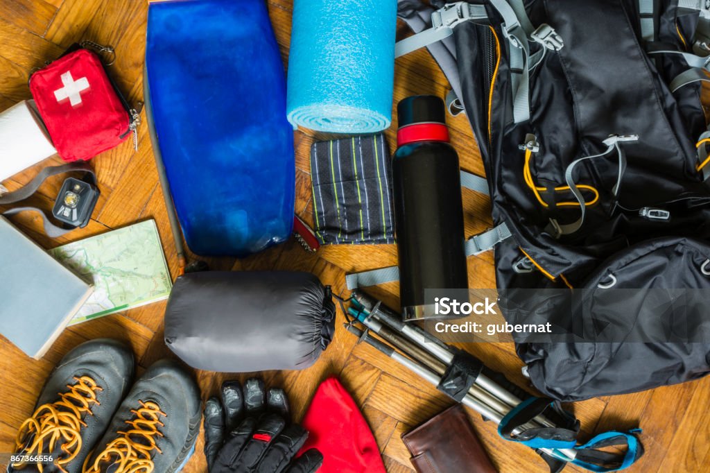 Equipment that would pack out on the trail. Equipment that would fit into a backpack to go out on a trail in the mountains. Hiking Stock Photo