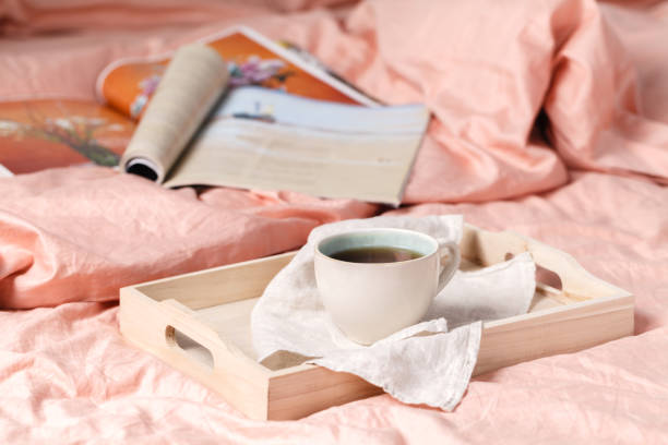 istock Wooden tray with tasty breakfast on bed 867369952
