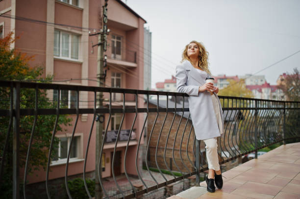 istock Stylish curly blonde model girl wear on white 867378982
