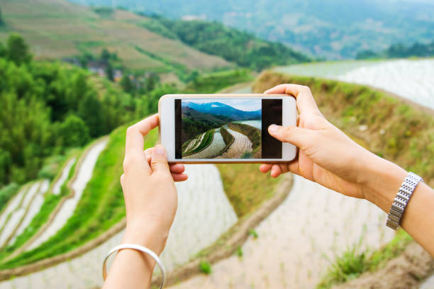 istock Girl capturing rice terrace scenery with a phone 867383248