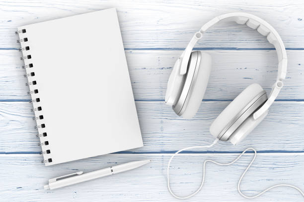 istock White Headphones, Notebook and Pen extreme closeup. 3d Rendering 867383588
