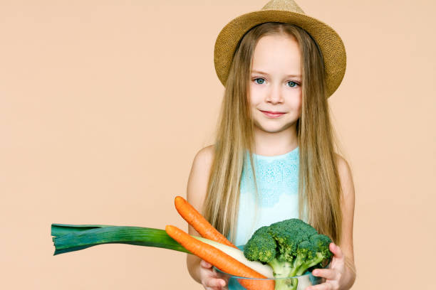 istock Little girl with vegetables. 867386850