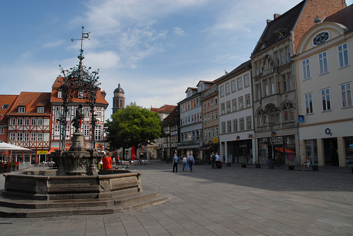 Goettingen, Germany - May 2017: Gänseliesel-fountain at the Town Square and St Jacobi Tower