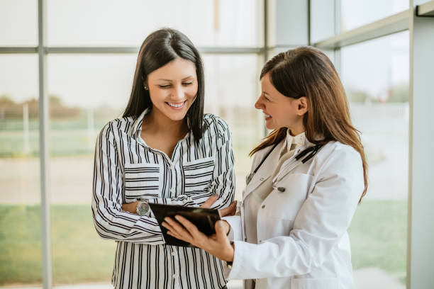 Doctor talking and laughing with her female patient.