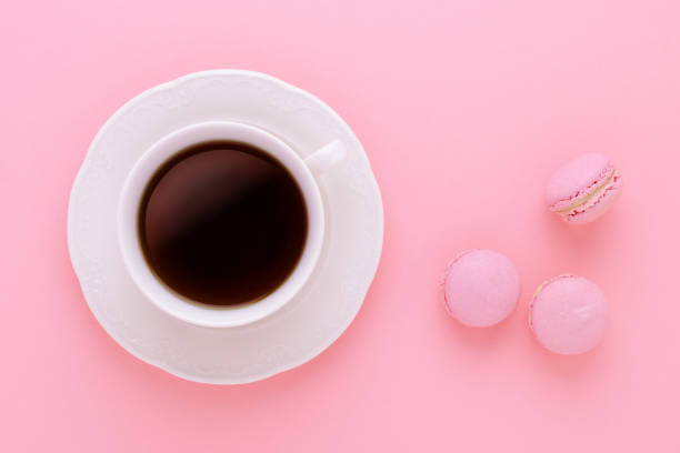 istock coffee cup black with handmade macaroons on pink background from above 867390542