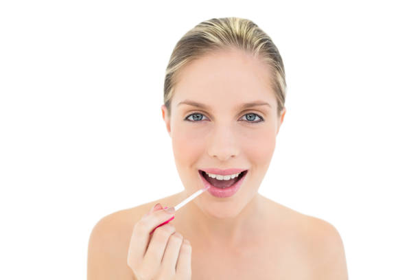istock Joyful fresh blonde woman applying gloss 867391204