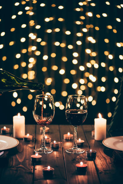 istock glasses of wine on table with candles 867395246