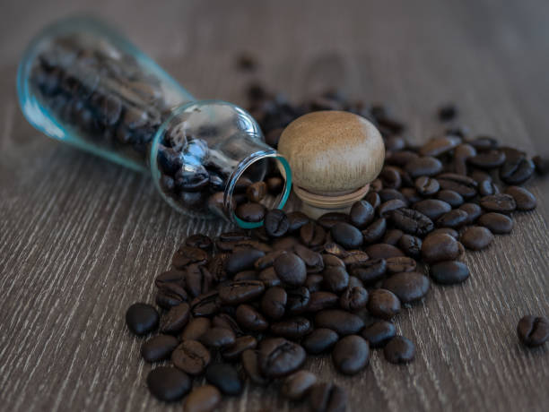 istock The selective focused image of coffee bean on the table with a glass bottle. 867395550