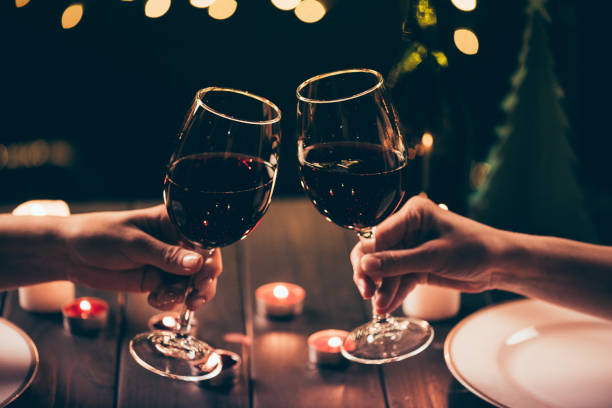 istock women clinking glasses over served table 867396082