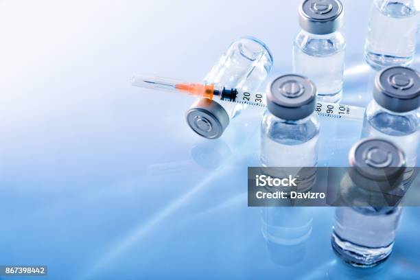 Vials And Syringe On Blue Table Top Elevated Stock Photo - Download Image Now - Syringe, Vial, Diabetes