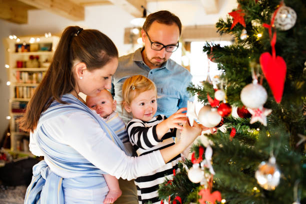 istock Young parents with two children at Christmas time. 867401762