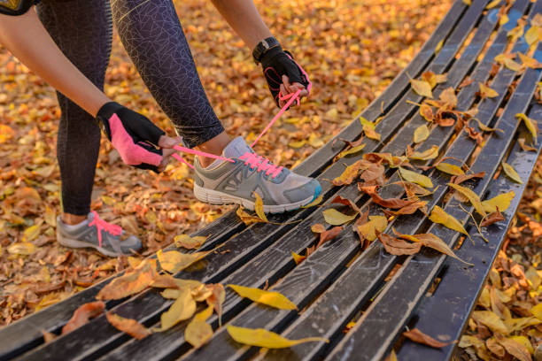 istock Hands tying trainers shoelaces on the autumn pave 867402362