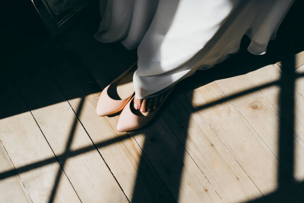 istock Bride is putting her leg in wedding shoes. Artwork. 867408986