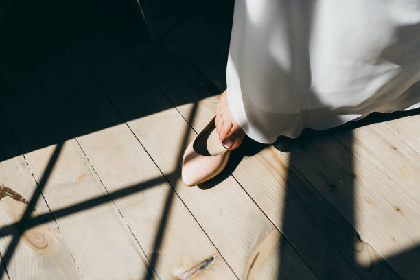 istock Bride is putting her leg in wedding shoes. Artwork. 867409032