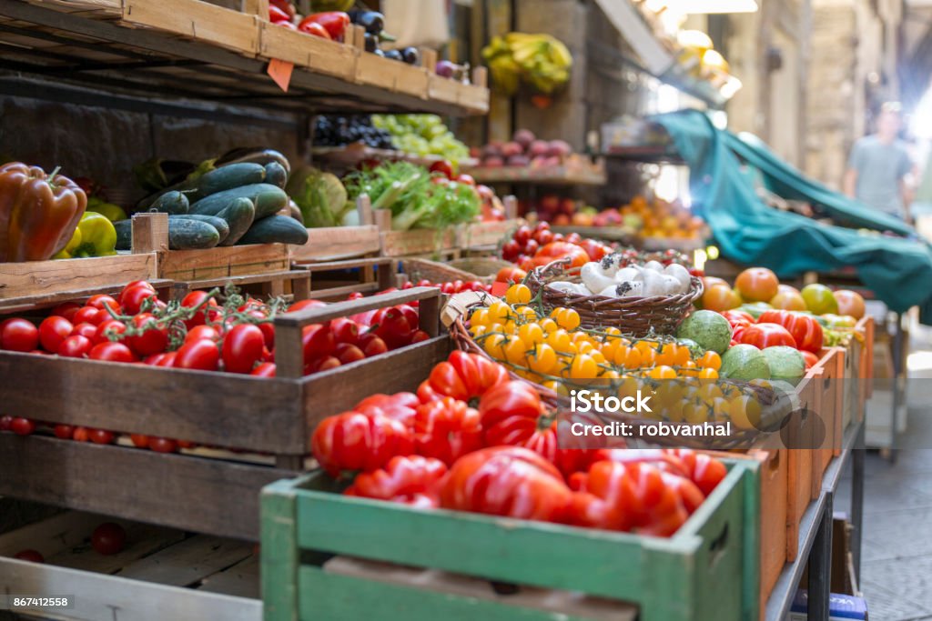 Fresh and healthy vegetables and colorful fruit Fresh and healthy vegetables and colorful fruit in front of a shop in a picturesque street in Italy Market - Retail Space Stock Photo