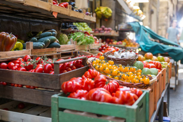 Fresh and healthy vegetables and colorful fruit Fresh and healthy vegetables and colorful fruit in front of a shop in a picturesque street in Italy mart stock pictures, royalty-free photos & images