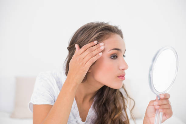 istock Serious attractive brunette looking at mirror 867437466