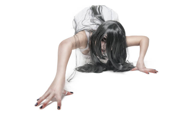 Voodoo Priestess crawling on the floor. This stock image has a horizontal composition.