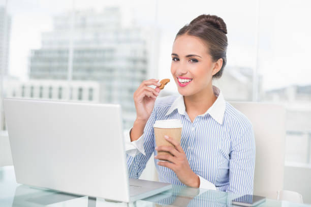 istock Smiling brunette businesswoman holding cookie 867459174
