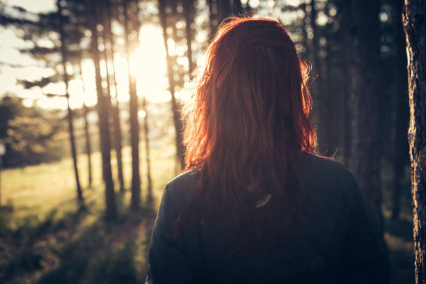 Woman in forest at suset