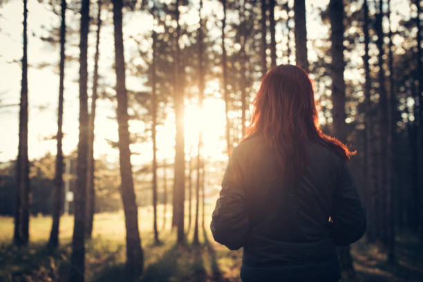 istock Woman in forest at suset 867460084
