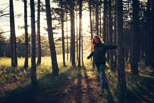 istock Woman in forest at suset 867460388