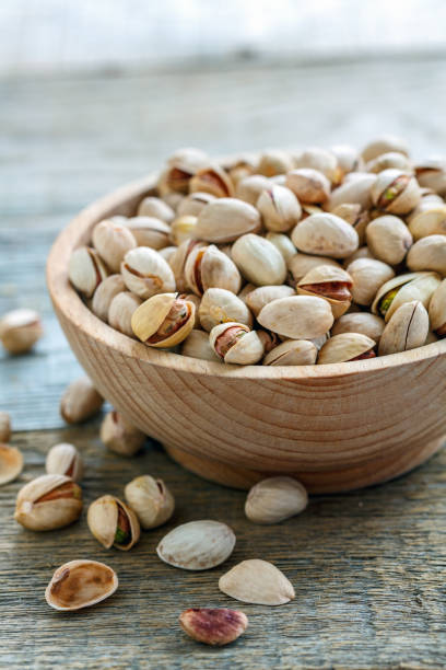 istock Wooden bowl with raw pistachios. 867466468