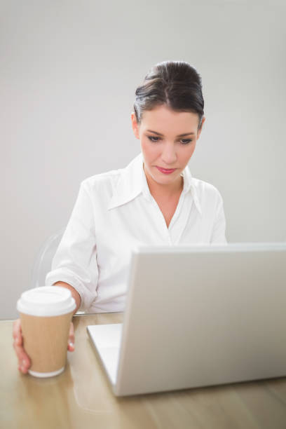 istock Pensive gorgeous businesswoman working on laptop 867483486