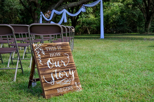 Image of an aisle entrance sign at an outdoor wedding