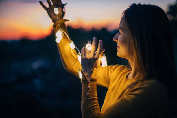 istock Cute girl holding the lights in dusk 867487030