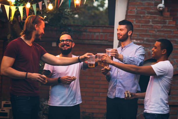 istock Male friends on a barbecue in back yard 867487548