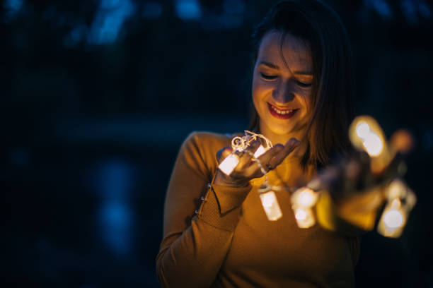 istock Brown haired girl holding the lights 867487740