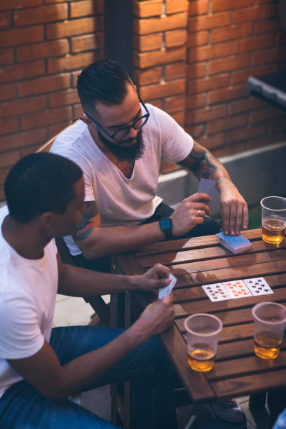 istock Male friends having fun in back yard 867487812