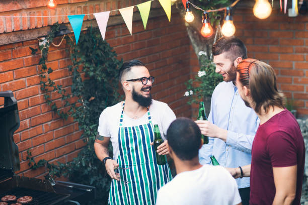 istock Male friends on a barbecue in back yard 867492028