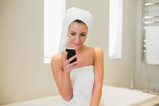 istock Pleased natural brown haired woman using her mobile phone 867493032