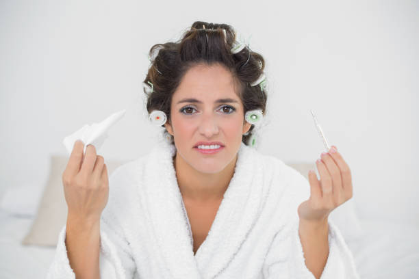 istock Desperate natural brunette holding thermometer and tissue 867499162