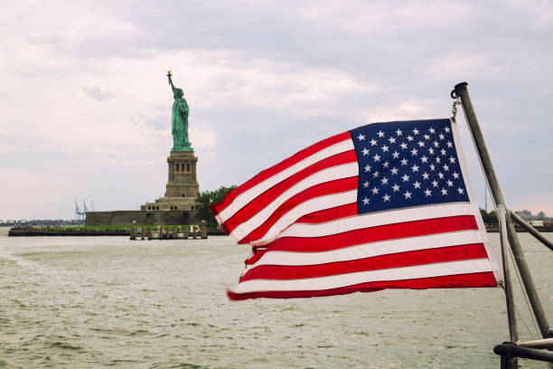 istock USA Flag and Statue of Liberty 867501704