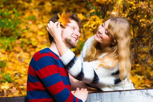 istock Lovers couple in autumn park on bench 867501886