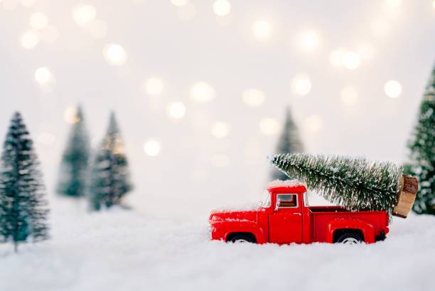 istock Red toy pickup car carrying Christmas tree 867502914