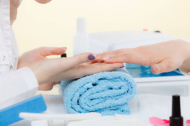 istock Woman hand on towel, next to manicure set 867503102