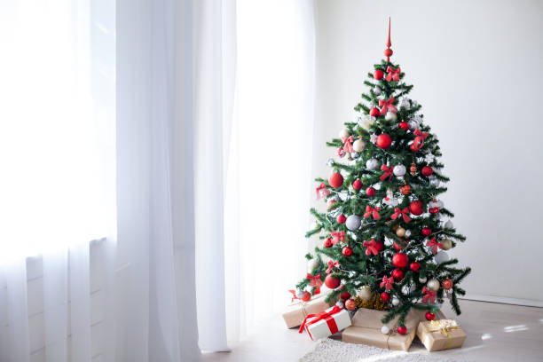 istock Christmas tree with red decorations new year gifts 867510244