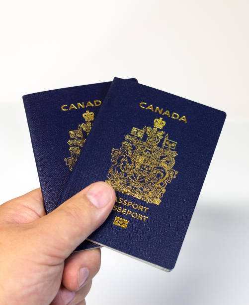 istock hand holding two Canadian passports 867510266
