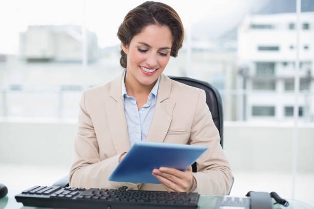 istock Smiling businesswoman looking at tablet 867512822