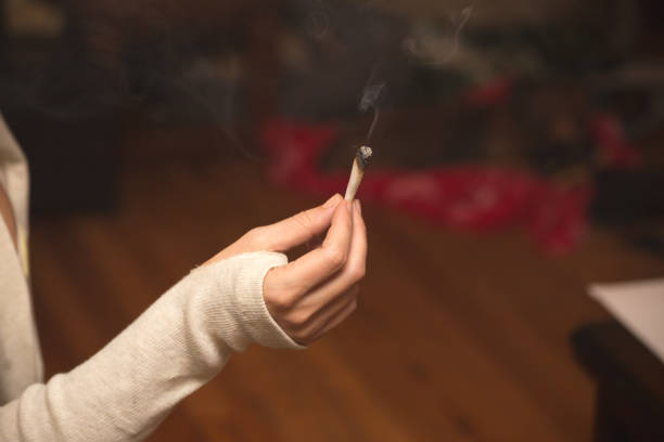 istock Woman Holding Burning Cigarette or Joint 867520198