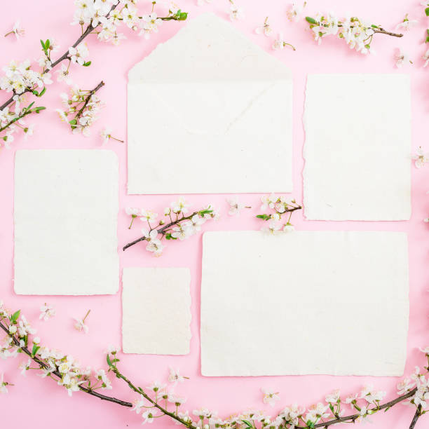 istock Frame of spring flowers and calligraphy cards on pink background. Flat lay, top view. 867520230