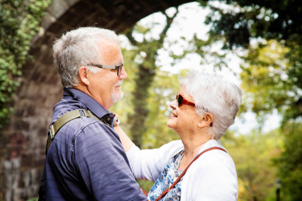 istock Senior couple having a romantic moment in Autumn while visiting a park 867520570