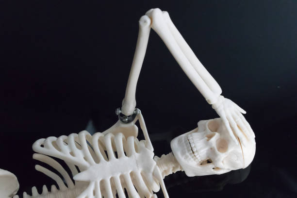 istock The worried skeleton laying on the black reflection plate 867531364