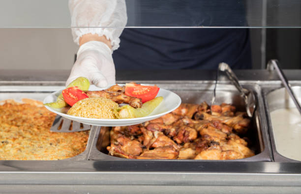 istock chef standing behind full lunch service station 867534098